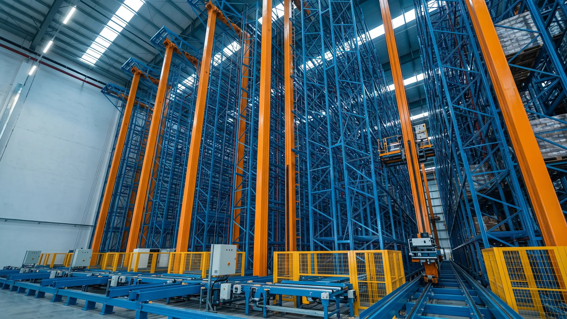 High-bay AS/RS stacker cranes with conveyor infeed
