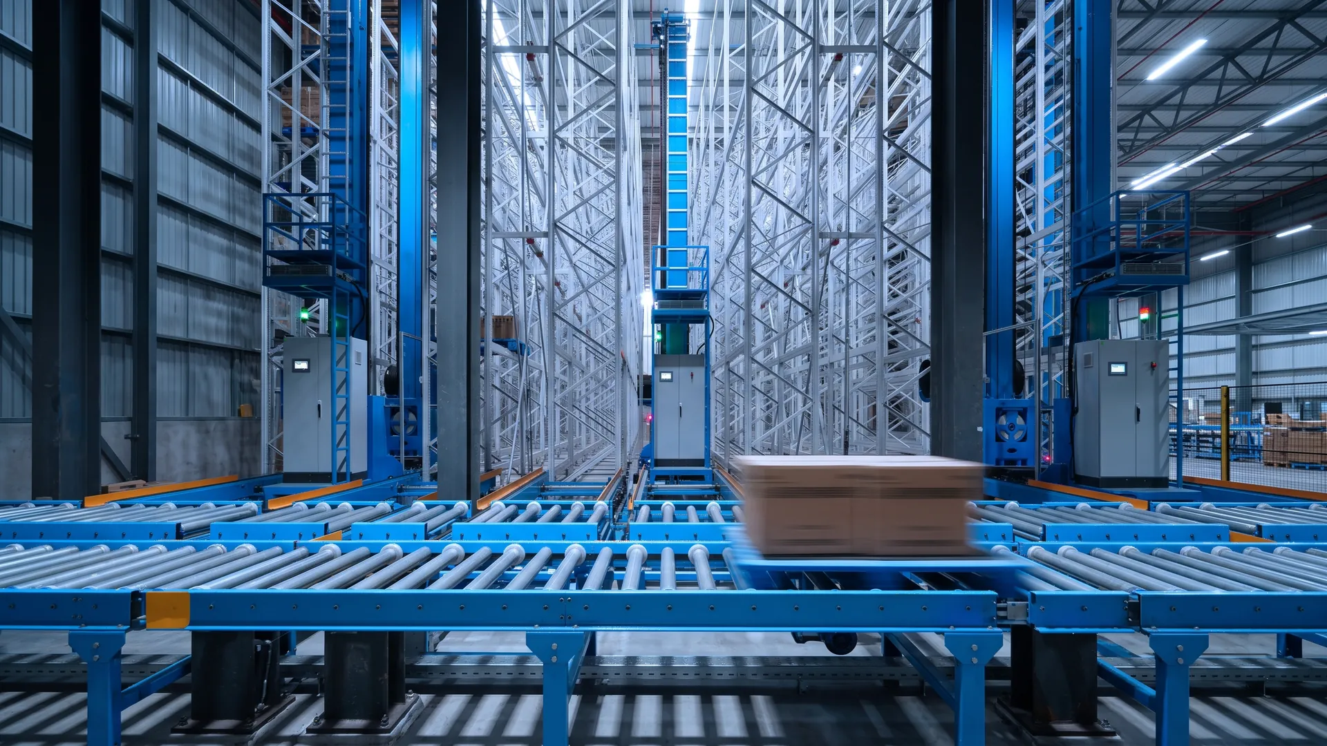 Roller conveyor network transferring cartons in an automated warehouse